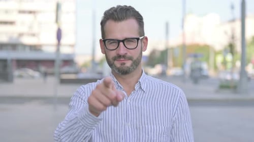 Bearded Man Gesturing Come Hither in City