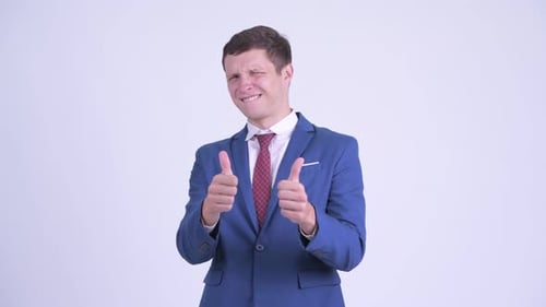 Enthusiastic Young Man in Suit Gives Thumbs Up