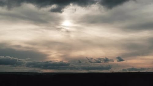 Clouds in the Sky Move Against the Background of the Sun at Sunset Timelapse