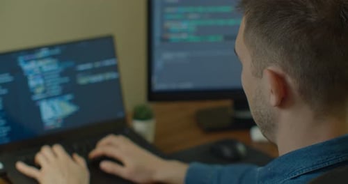 Man Typing on Computer at Desk