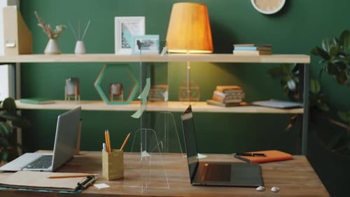 Table with Glass Barrier in Empty Office during Pandemic