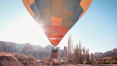 Hot Air Balloon Soaring Over Desert Landscape