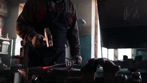 Blacksmith Forging Red-Hot Metal in Workshop