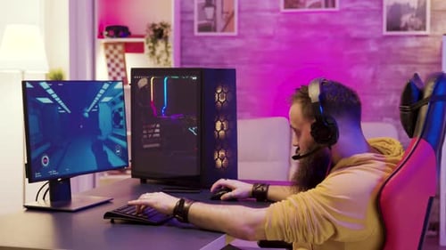 Young Adult Playing Video Game on Powerful PC