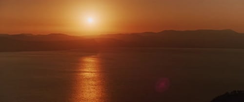 Beautiful landscape with sunset over the big lake and the mountains