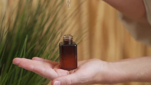 Dropping Serum into Bottle for Skincare