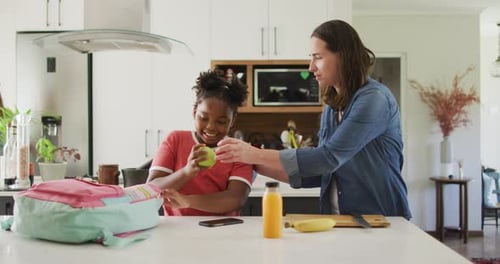 Mother and Child Preparing Lunch in Bright Kitchen