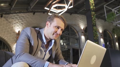 Happy Businessman working with laptop.