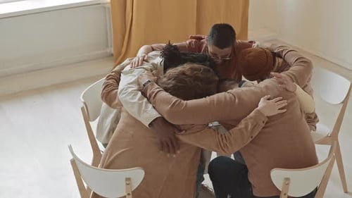 Group of People Hugging in Circle