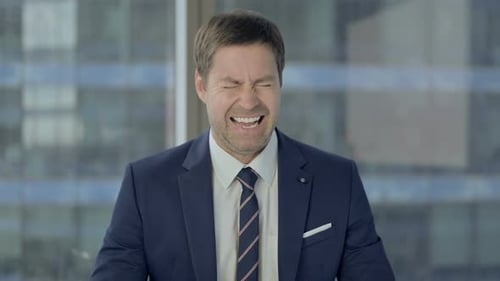 Annoyed Businessman Showing Frustration in an Office Setting