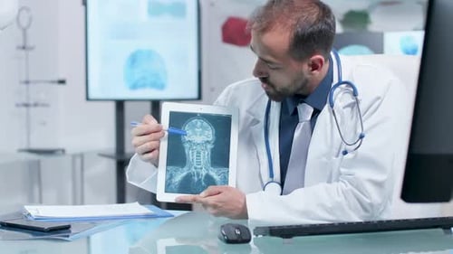 Doctor Showing a X Ray Scan on a Digital Tablet PC