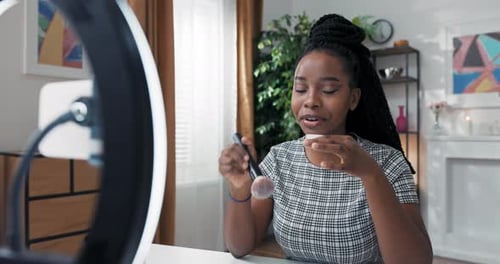 Shot From Behind Ring Light of Makeup Artist Conducting Live Online Reviews of New Cosmetic Brand