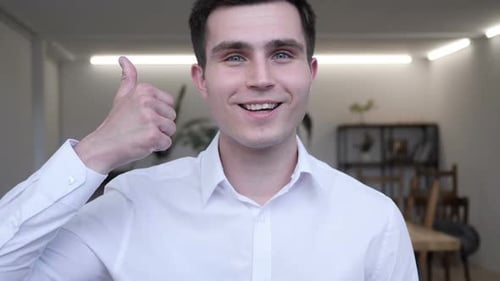 Young Adult Gives Thumbs Up in Office