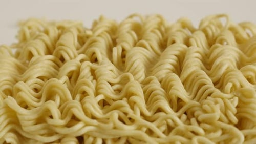 Tilting over instant Chinese noodles on white background close-up 4K 2160p 30fps UltraHD footage -