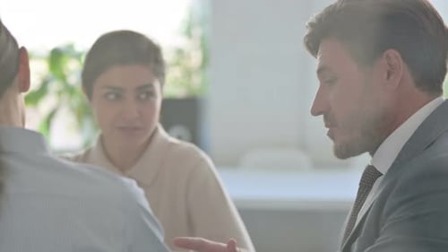 Close up of Serious Male and Female Business People Talking