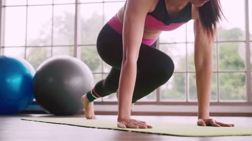 Woman Doing Mountain Climber Exercise on Yoga Mat