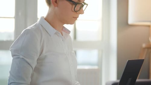Young Adult Working on Laptop in Home Office