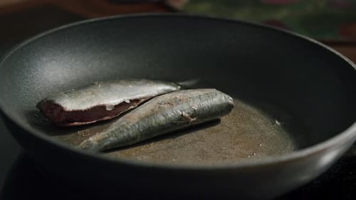 Fresh Sardines Cooking in a Frying Pan