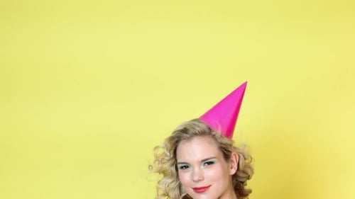 Cheerful Woman Celebrates with Party Noisemaker