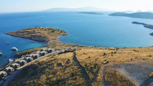 Aerial Fly Over Island with Resort Houses By the Sea