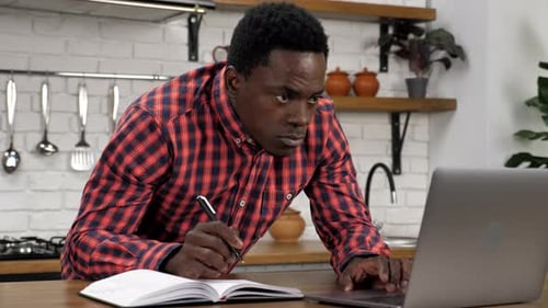 African American Man Student Study Does Homework for University with Laptop