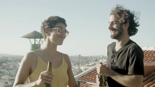 Friends Toasting with Beers on Sunny Rooftop