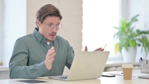 Man Working on Laptop Looking Surprised and Sad