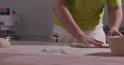 Baker Preparing Dough on Flour-Covered Wooden Counter