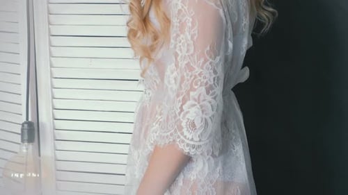 Woman in Lace Robe in Bright Room