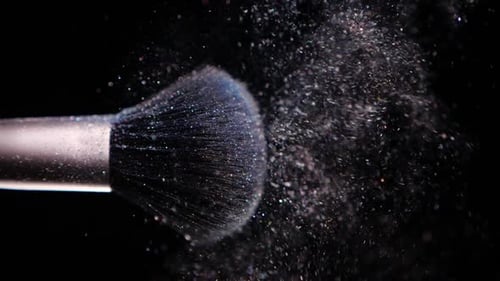 Make Up Brush with Colored Powder at Black Background Slow Motion Concept