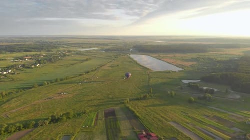 Hot Air Balloon Over Rolling Countryside at Sunrise