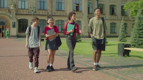 Happy Diverse Multiracial College Students Walking After Lecture at Campus