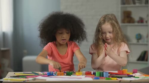 Two Young Girls Enjoying Finger Painting Together