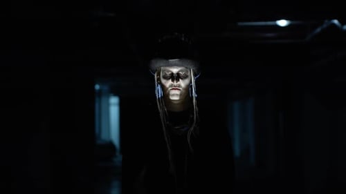 Creepy Man with Skeleton Makeup Appearing From Darkness When Light Falls on Him, Making Faces