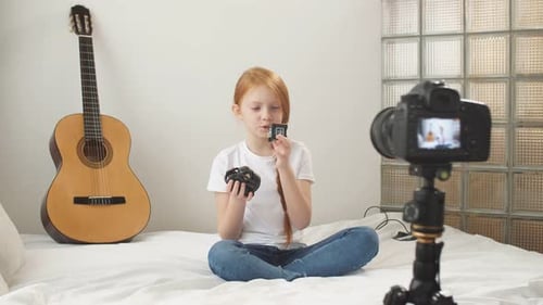 Girl Films Robot Video on Bed at Home