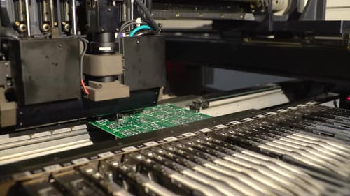 Automated Machinery Placing Electronic Components on Board