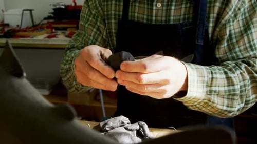 Adult Shaping Clay in Studio Close Up