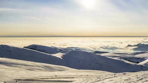 Snowy Mountain Landscape with Skiers on a Sunny Day