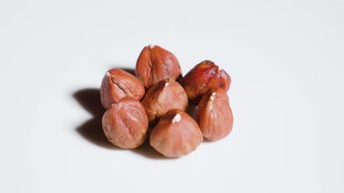 Close Up of Hazelnuts on White Surface