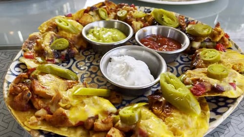 Close Up of Nachos and Dipping Sauces