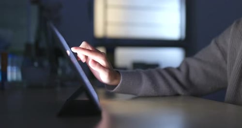 Typing on Tablet Computer at Night