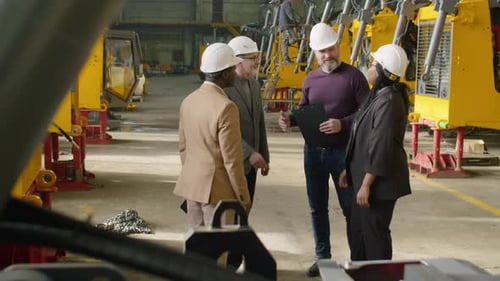 Engineers Shaking Hands and Talking during Visit to Factory