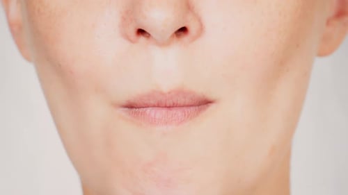 Woman Eats Vegetable in Close Up