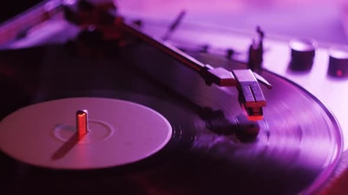 Record Player Spinning Vinyl Under Purple Lighting