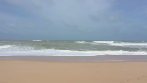 waves and white foam on the sand