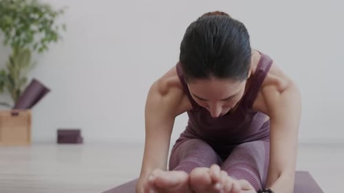 Sportswoman Exercising in Stretching Studio