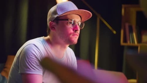 Man Playing Video Games at Home at Night