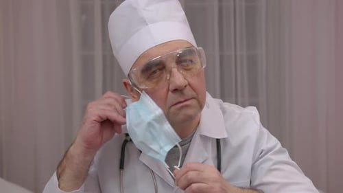 Doctor removes mask and smiles