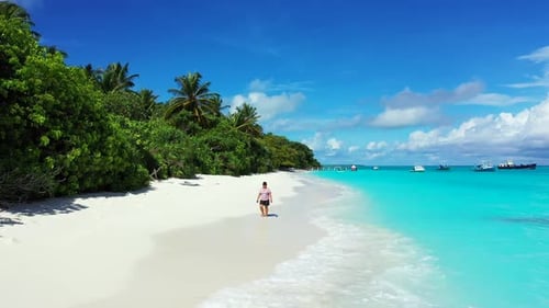Female model tanning on tranquil lagoon beach adventure by turquoise ocean and white sandy backgroun