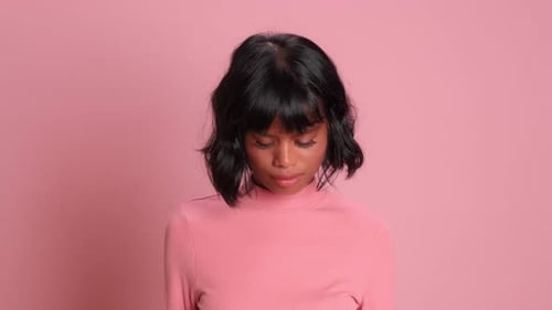 Woman Looks Down with an Upset Expression